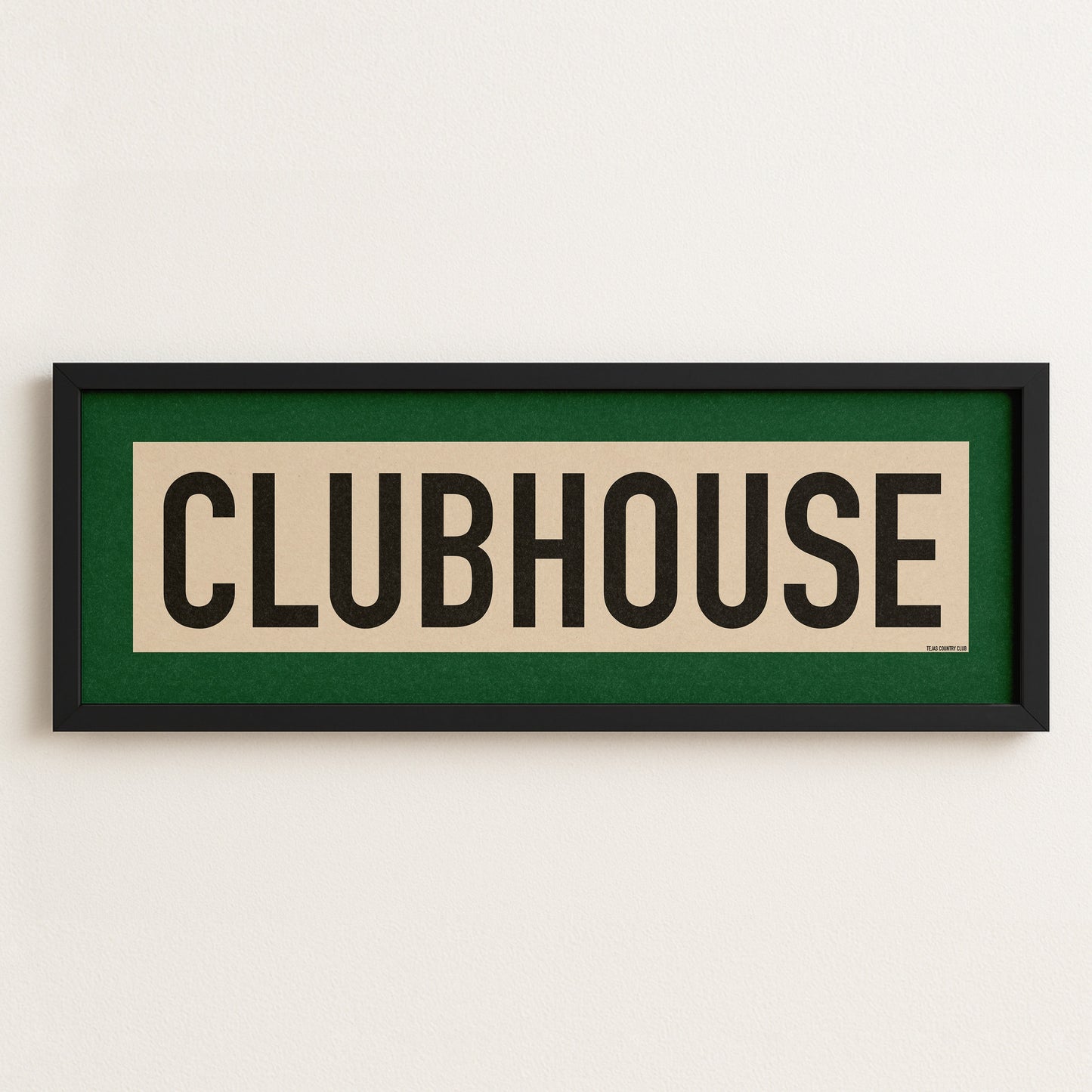 Framed sign with 'CLUBHOUSE' text on a white wall