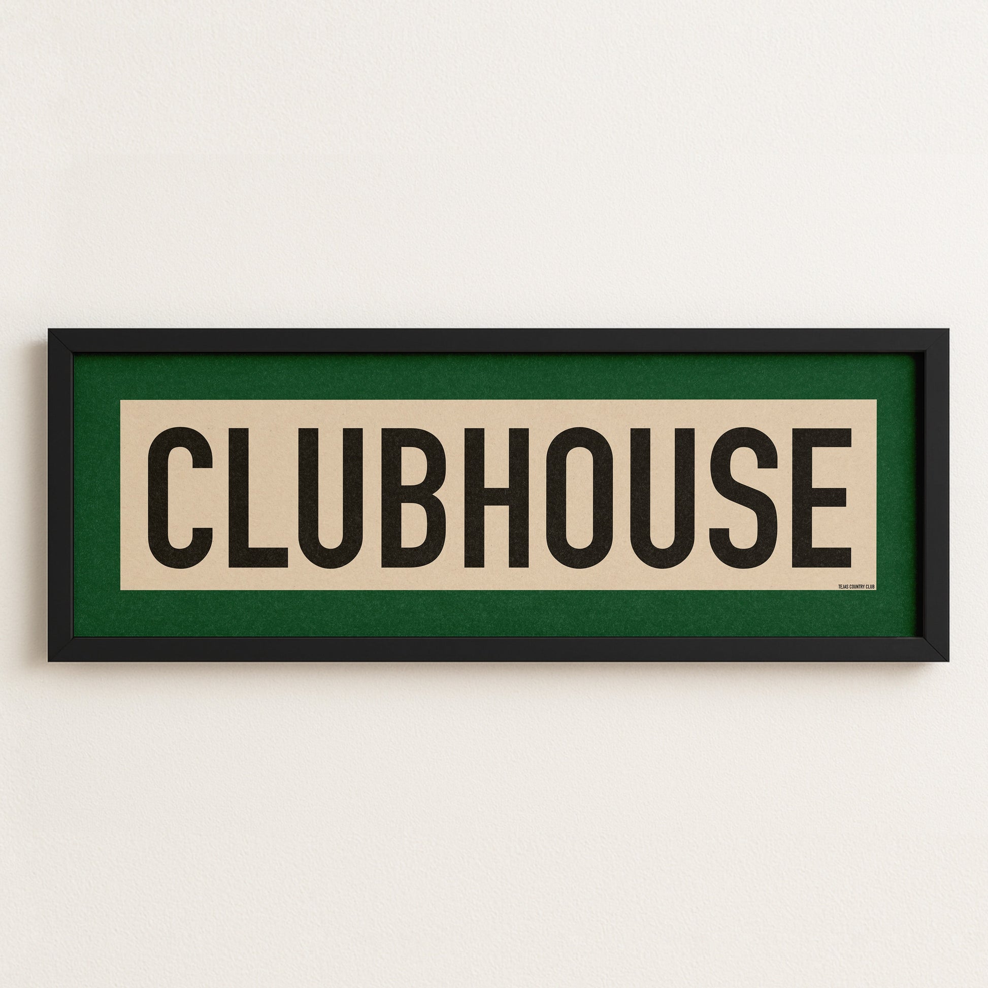 Framed sign with 'CLUBHOUSE' text on a white wall