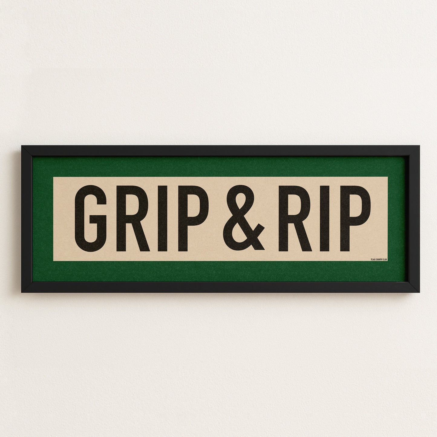 Framed sign with 'GRIP & RIP' text on a white wall