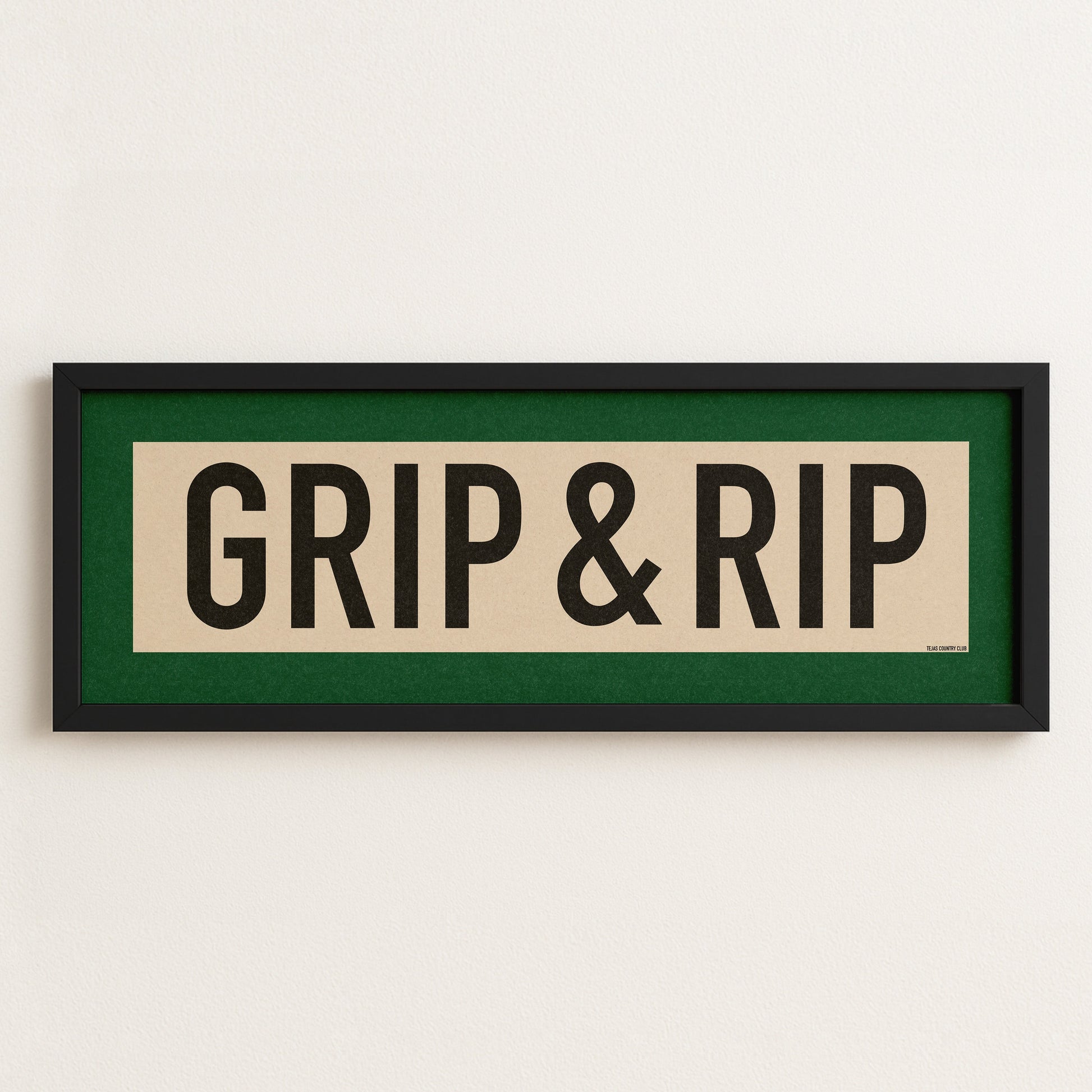 Framed sign with 'GRIP & RIP' text on a white wall
